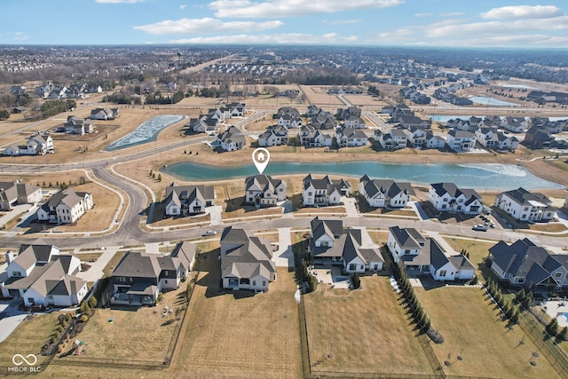 birds eye view of property with a residential view and a water view