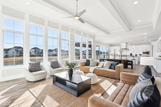 living area with recessed lighting, visible vents, a ceiling fan, light wood-type flooring, and beam ceiling