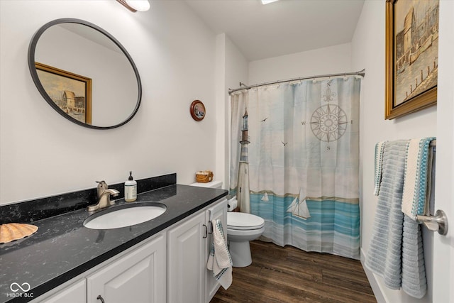 full bath featuring curtained shower, vanity, toilet, and wood finished floors