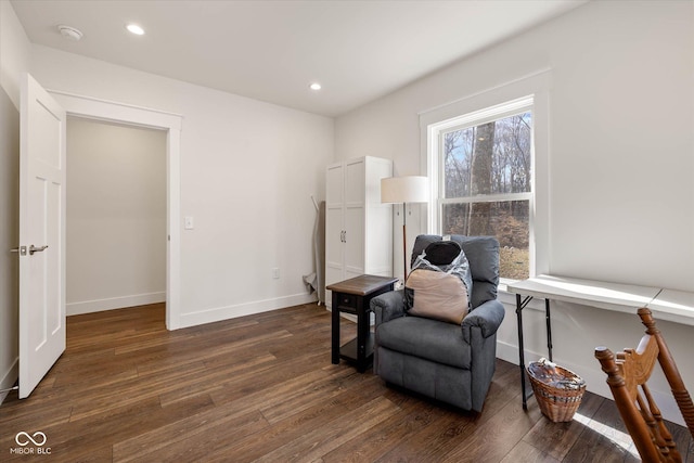 sitting room featuring baseboards, dark wood-style flooring, and recessed lighting