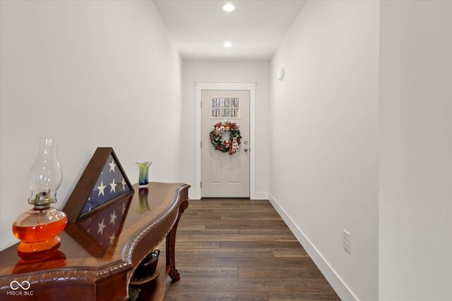 doorway featuring recessed lighting, dark wood-style flooring, and baseboards