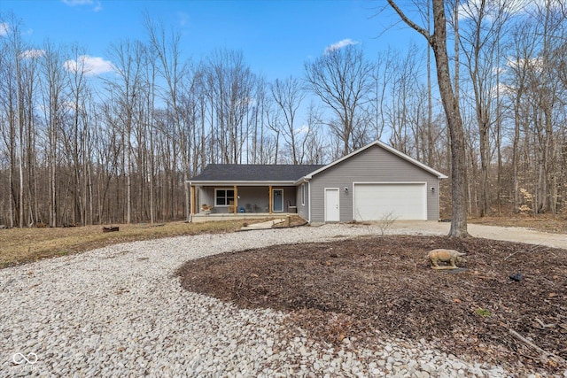 ranch-style house featuring a garage, concrete driveway, and a porch