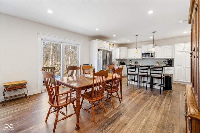 dining area with recessed lighting, baseboards, and hardwood / wood-style floors