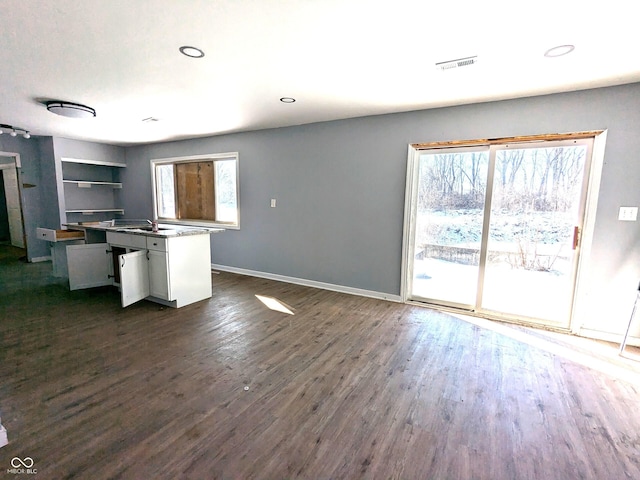 kitchen featuring dark wood-style floors, recessed lighting, white cabinetry, and baseboards