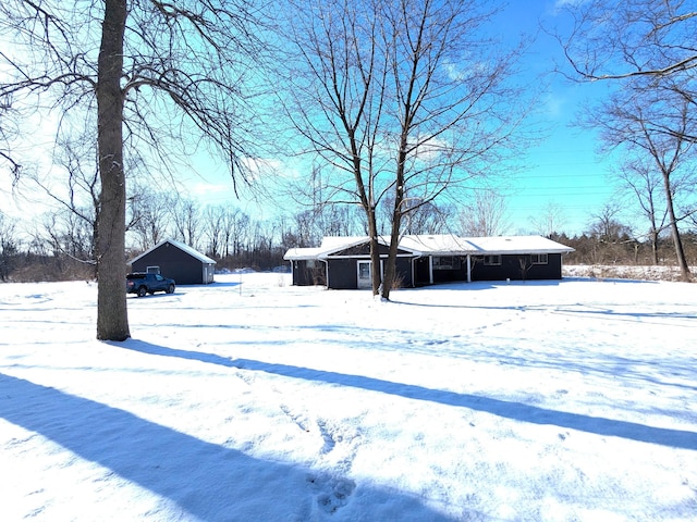 snowy yard featuring a garage