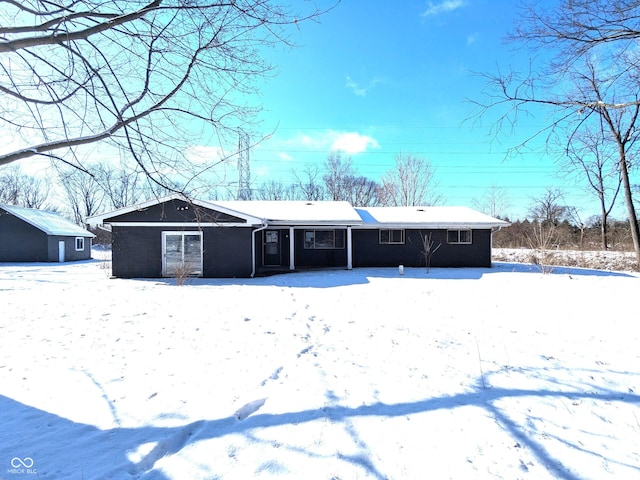 view of snow covered back of property