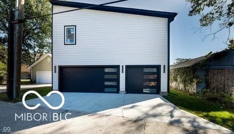 view of property exterior with concrete driveway and an attached garage