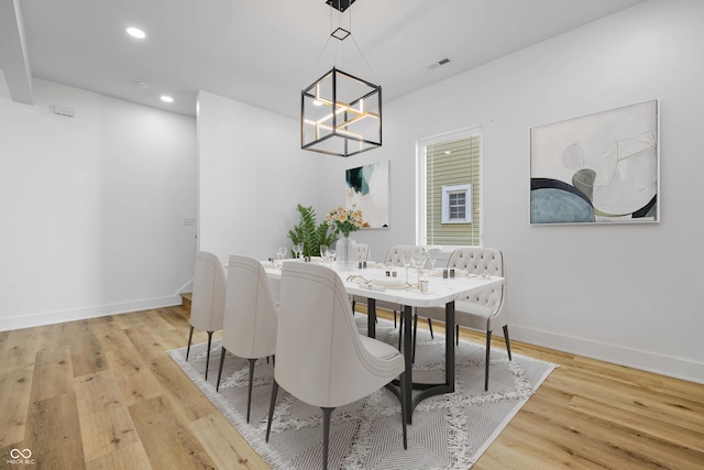 dining space featuring baseboards, visible vents, light wood-type flooring, a notable chandelier, and recessed lighting