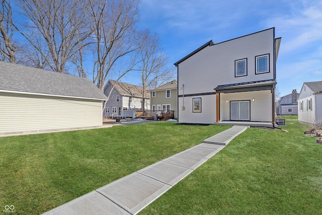 back of property with a residential view and a lawn