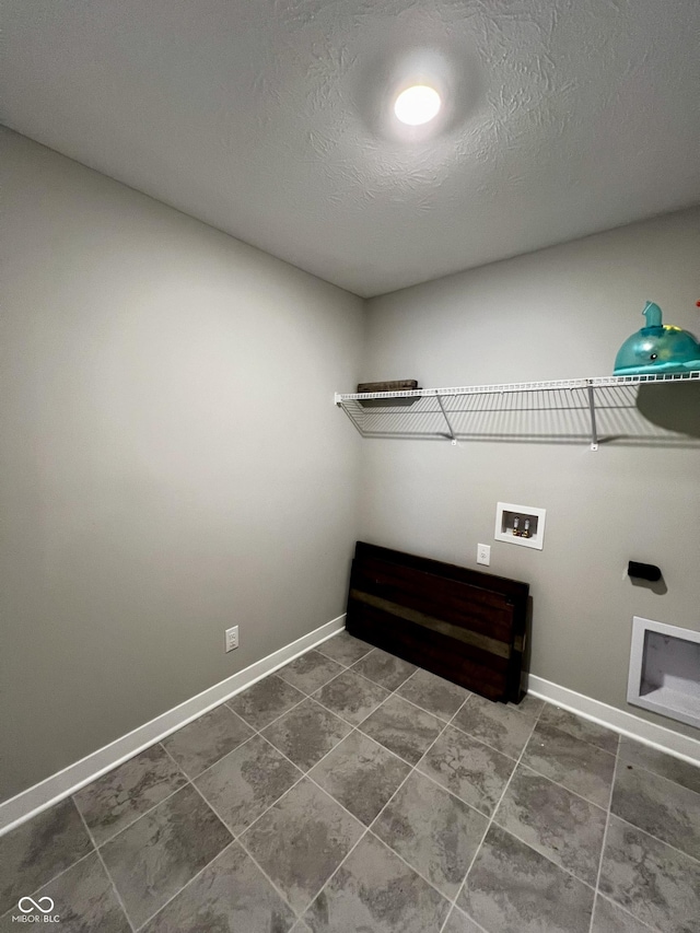 laundry area featuring laundry area, hookup for a washing machine, baseboards, and a textured ceiling