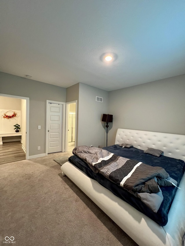 bedroom featuring carpet floors, baseboards, and visible vents