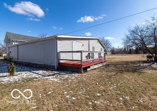 view of home's exterior featuring a yard and a deck