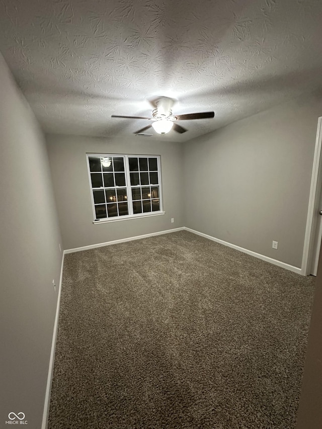 carpeted empty room featuring a textured ceiling, baseboards, and a ceiling fan