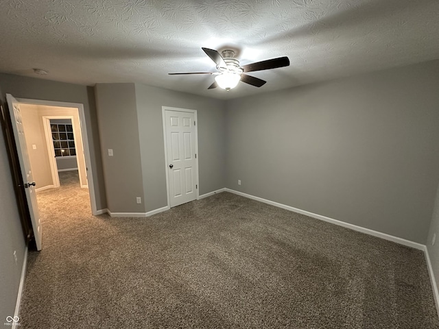 unfurnished bedroom featuring a ceiling fan, carpet flooring, a textured ceiling, and baseboards