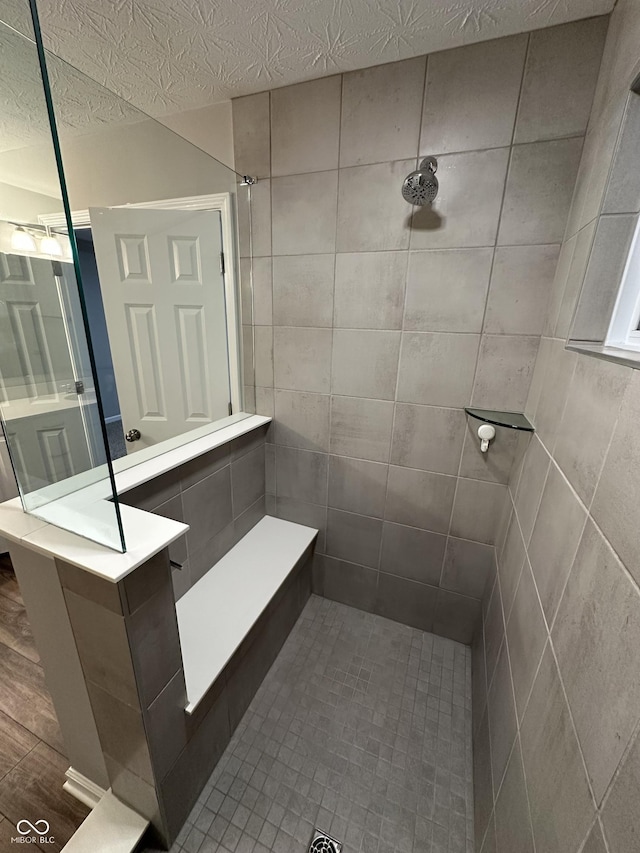4187 Risen Star Way, Bargersville, IN 46106 - bathroom featuring tiled shower and a textured ceiling