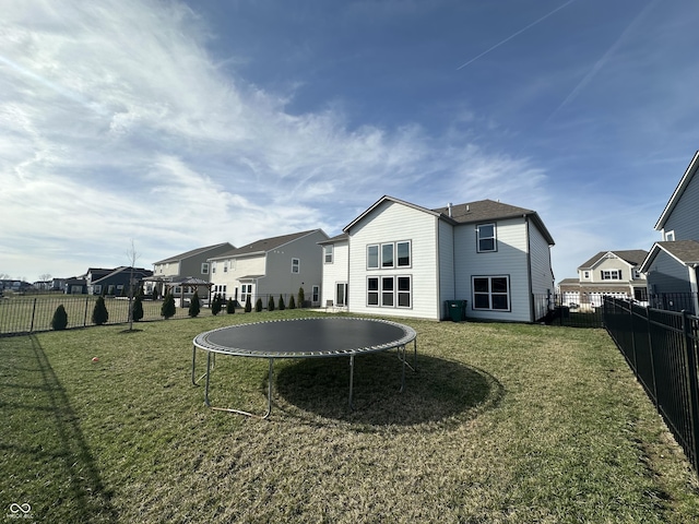4187 Risen Star Way, Bargersville, IN 46106 - rear view of property with a fenced backyard, a residential view, a yard, and a trampoline
