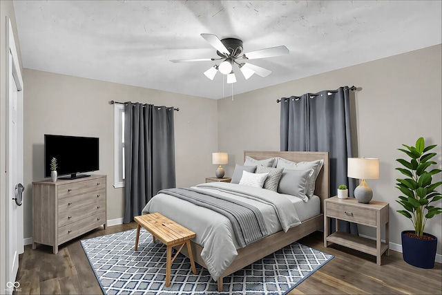 bedroom featuring dark wood-style floors, ceiling fan, and baseboards