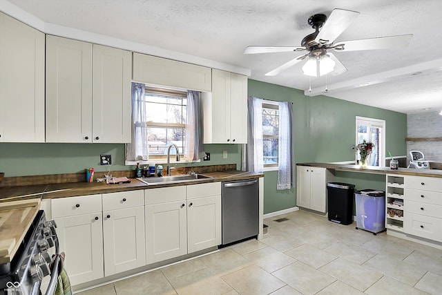 kitchen with appliances with stainless steel finishes, a healthy amount of sunlight, white cabinets, and a sink