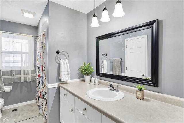 full bath featuring toilet, visible vents, baseboards, vanity, and tile patterned floors