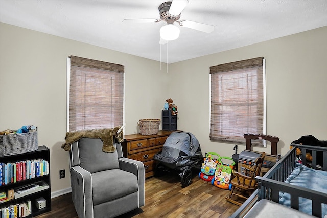 bedroom with dark wood-style flooring and a ceiling fan