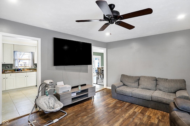 living room featuring wood finished floors and a ceiling fan