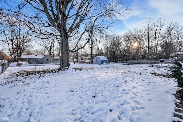 yard covered in snow with fence