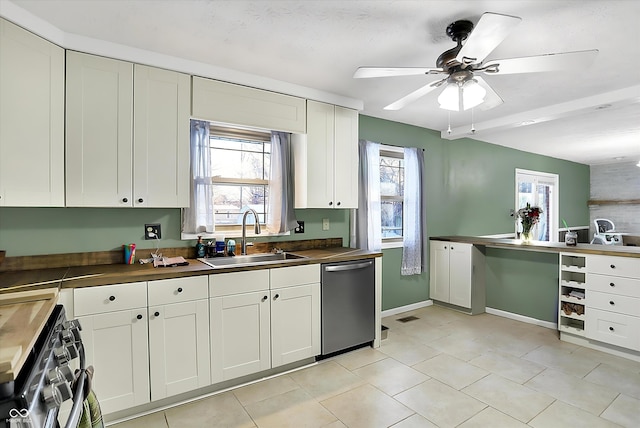 kitchen with a wealth of natural light, white cabinetry, appliances with stainless steel finishes, and a sink