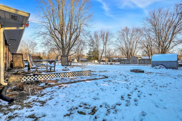 yard covered in snow featuring fence