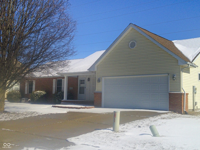 single story home with brick siding and an attached garage