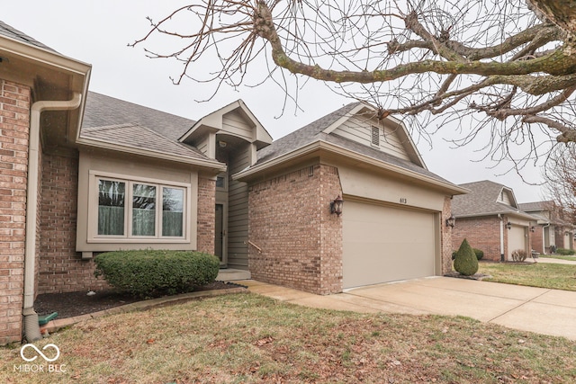 view of front facade with driveway, a shingled roof, an attached garage, and brick siding