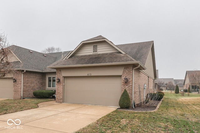 view of front of house featuring brick siding, a shingled roof, concrete driveway, an attached garage, and a front yard