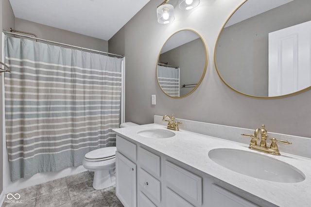 full bath featuring a sink, toilet, and double vanity