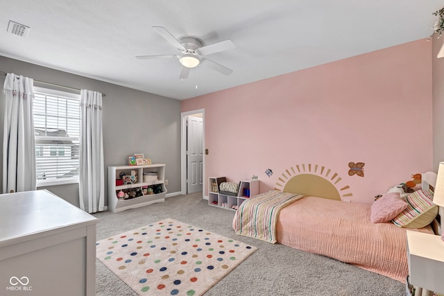 bedroom with a ceiling fan, visible vents, light carpet, and baseboards