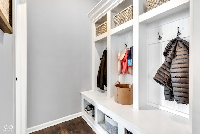 mudroom with baseboards and dark wood-type flooring