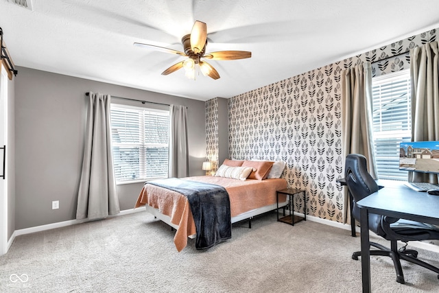 bedroom with wallpapered walls, multiple windows, baseboards, and carpet flooring