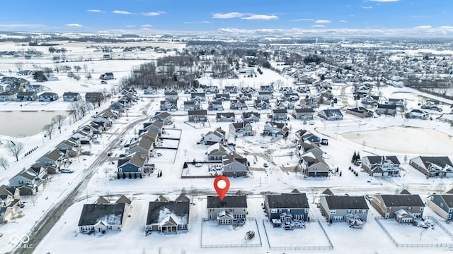 snowy aerial view featuring a residential view