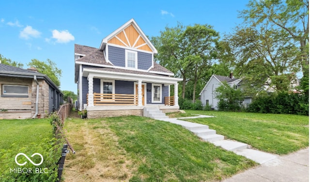 view of front of house featuring covered porch, roof with shingles, board and batten siding, and a front yard