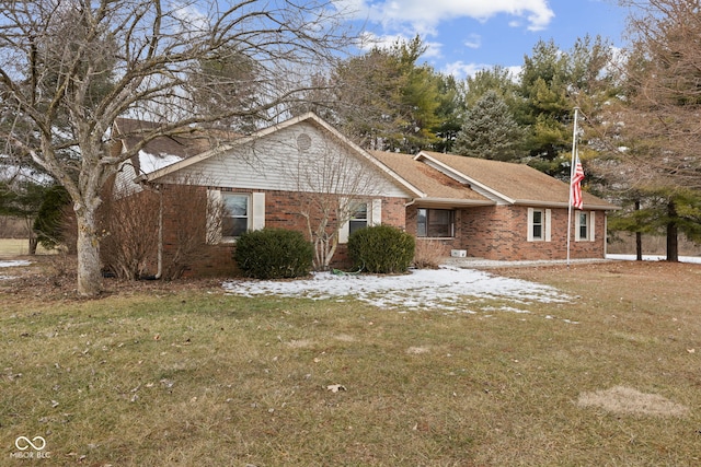 ranch-style house with brick siding and a front yard