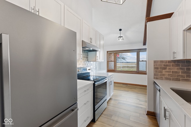 kitchen featuring pendant lighting, light wood finished floors, appliances with stainless steel finishes, white cabinets, and under cabinet range hood