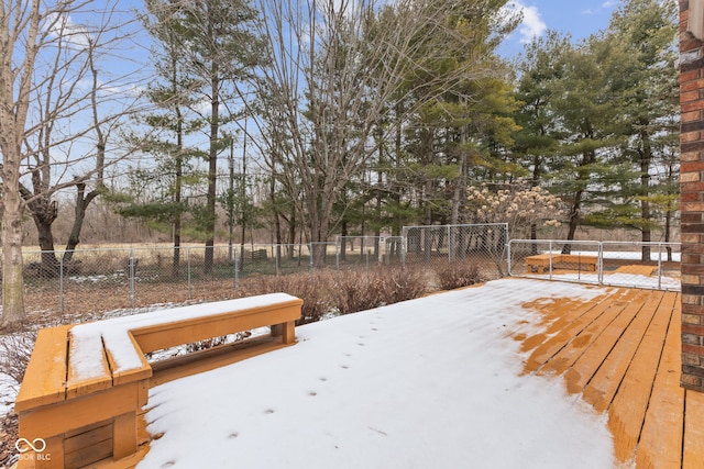 snowy yard with fence