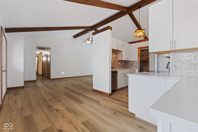 kitchen with a ceiling fan, white cabinets, light countertops, and light wood finished floors