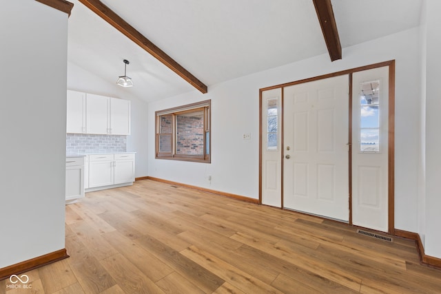 entryway featuring vaulted ceiling with beams, light wood-type flooring, visible vents, and baseboards