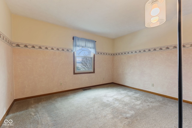 unfurnished room featuring baseboards, visible vents, and light colored carpet