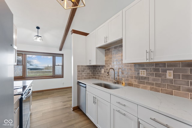 kitchen featuring appliances with stainless steel finishes, light stone counters, hanging light fixtures, white cabinetry, and a sink