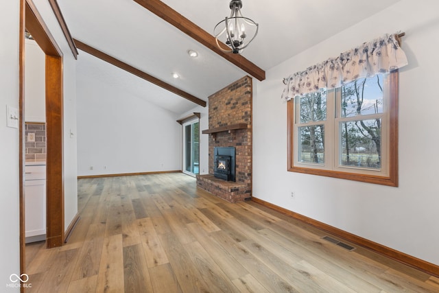 unfurnished living room featuring lofted ceiling with beams, visible vents, baseboards, light wood-style floors, and a brick fireplace