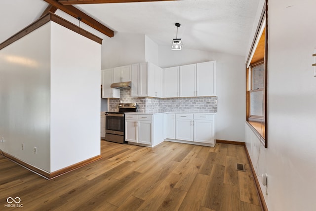 kitchen with stainless steel electric range oven, hanging light fixtures, light countertops, under cabinet range hood, and white cabinetry