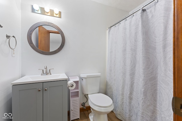 bathroom featuring toilet and vanity