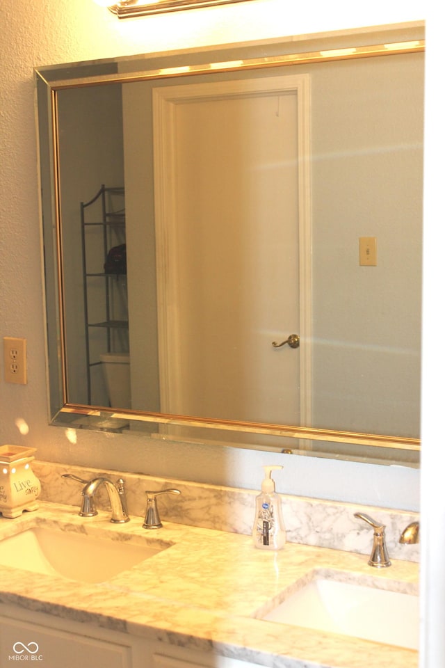 bathroom featuring double vanity and a sink