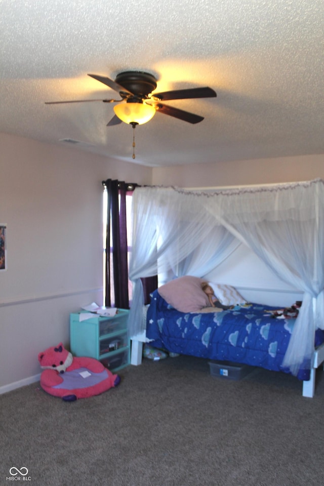 bedroom with a textured ceiling, carpet flooring, and a ceiling fan