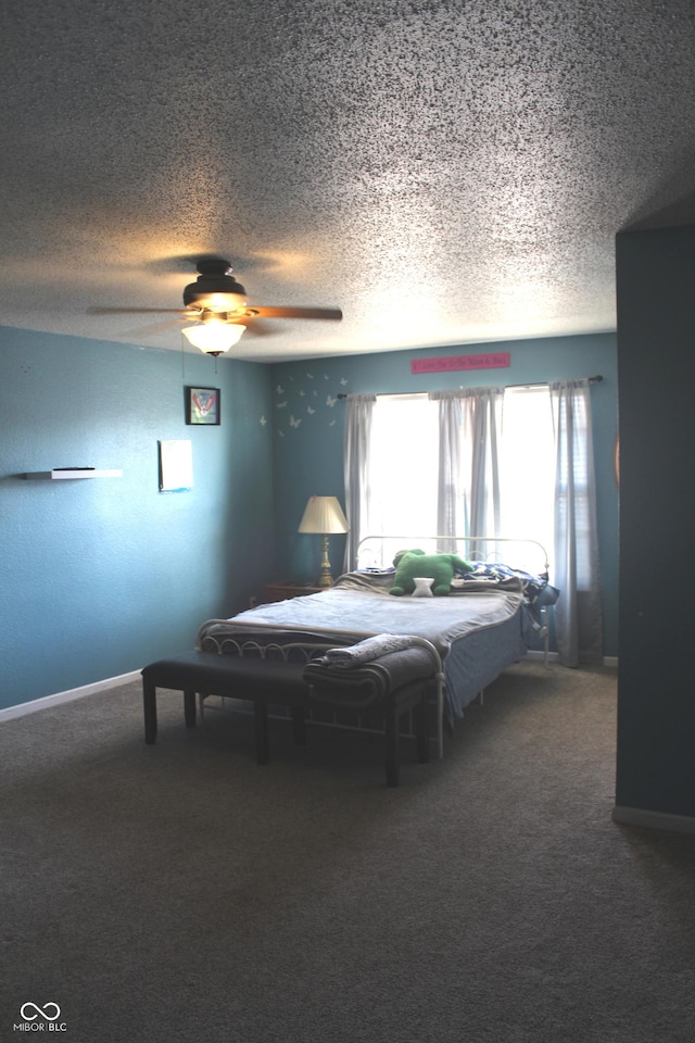 carpeted bedroom featuring a textured ceiling, ceiling fan, and baseboards